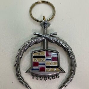 Cadillac crest and wreath emblem metal keychain accessory.